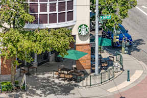 an aerial view of a building with a starbucks sign on the side of it