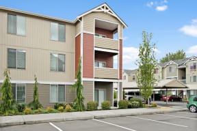 a parking lot in front of an apartment building