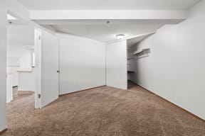 a renovated living room with a carpeted floor and white walls