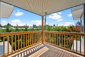 the view from the deck of a house with a wooden railing