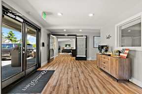 a living room with a hard wood floor and glass doors