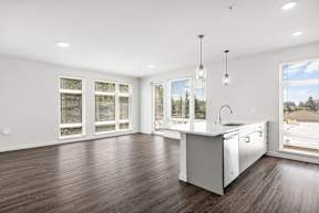 a living area with hardwood floors and white walls