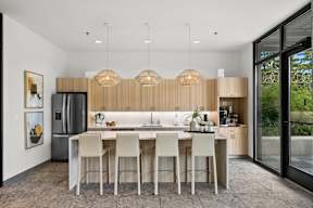 a kitchen with wooden cabinets and a large island with stools