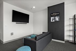 a living room with a couch and a tv on the wall