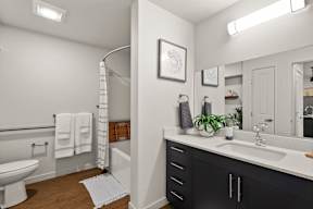 a bathroom with a large mirror  at Telka Apartments, Silverdale, Washington