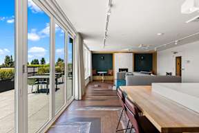 A modern interior with a long wooden table and chairs.