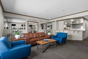 a living room with couches and chairs and a kitchen