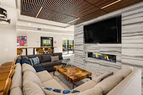 A modern living room with a fireplace and a flat screen TV.
