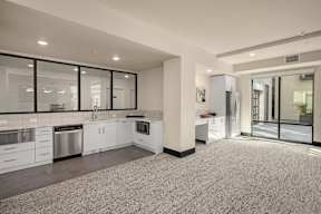 A spacious kitchen with white cabinets and stainless steel appliances.