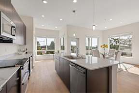 A modern kitchen with a large island and stainless steel appliances.