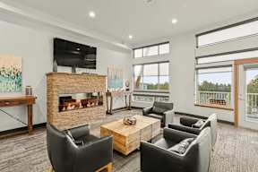 A living room with a fireplace and a balcony.
