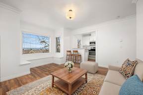 A living room with a brown coffee table and a blue cushion.