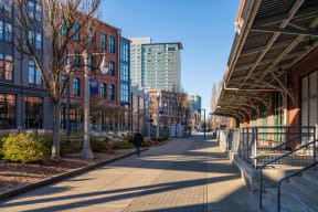 a man walking down a sidewalk in front of buildings in the city