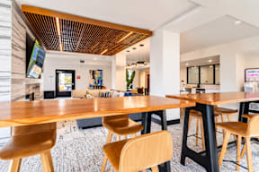 A modern dining room with a wooden table and chairs.