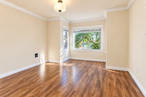 A room with wooden floors and a window.
