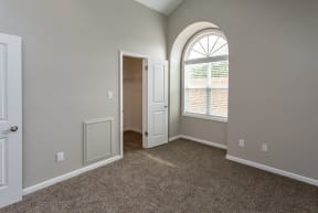 diamond bedroom with arched window and walk-in closet