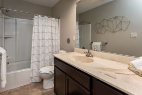 bathroom with tub and large cabinet spaces