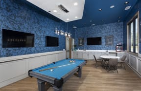 game hall with pool table, tvs, and seating