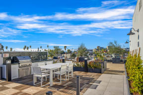 rooftop with seating area and grills