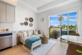a living room with a couch and a table and a balcony