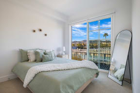 a bedroom with a bed and a large window