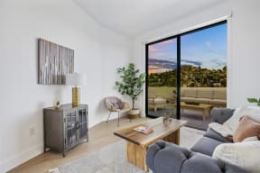 a living room with a couch and a coffee table and a sliding glass door