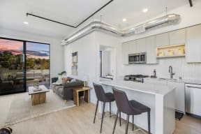 a living area with a kitchen and a couch and a table