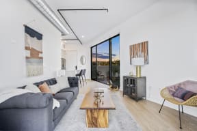 a living room with a gray couch and a wooden coffee table
