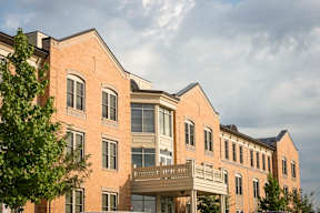 A large building with a balcony and multiple windows.
