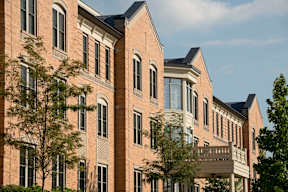 A large brick building with a balcony on the second floor.