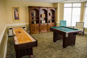 Senior Housing Game Room with pool table and shuffle board