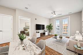 A living room with a white ceiling and a large window.
