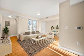 A living room with a white couch and a coffee table.