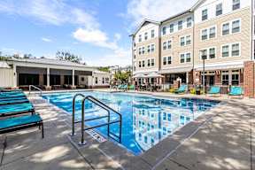 Resort-style pool and lounge area at The Flats at Tioga Town Center apartments in Newberry, FL.