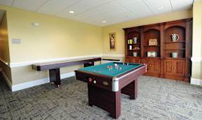 Senior Housing Game Room with pool table and shuffle board