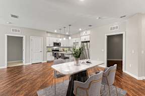 Open-plan kitchen and dining with marble table and stainless appliances, Apartments in Newberry, FL.