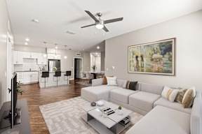 Open-concept living room and kitchen at The Flats at Tioga Town Center, apartments in Newberry, FL.