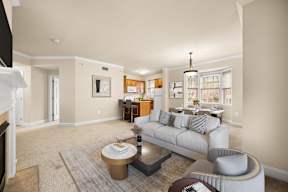 Spacious living room with a comfortable grey couch and a chic coffee table at Claremont Apartments in Exton, PA
