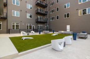an outdoor lounge area at the bradley braddock road station apartments