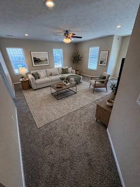 A living room with a couch, chair, and coffee table.