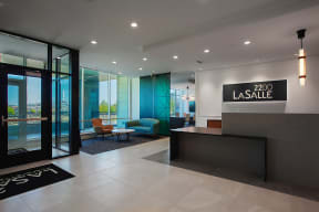 a modern hotel lobby with a pool in the background