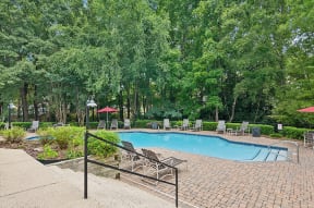 Community Swimming Pool with Pool Furniture at Park at Caterina Apartments located in Charlotte, NC.