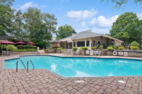 Community Swimming Pool with Pool Furniture at Park at Caterina Apartments located in Charlotte, NC.