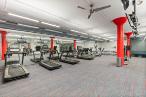 a gym with treadmills and other exercise equipment in a large room