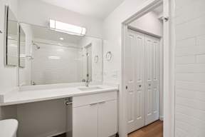 A white bathroom with a white toilet and sink.