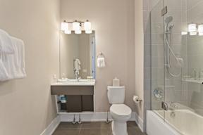 a bathroom with a toilet and a sink and a shower