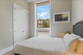 a bedroom with a large bed and a window