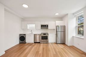 A kitchen with white cabinets and stainless steel appliances.