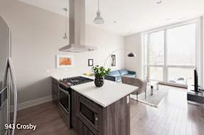 a kitchen with a large island and a living room with a couch