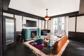 a living room with a brown leather couch and a green fireplace